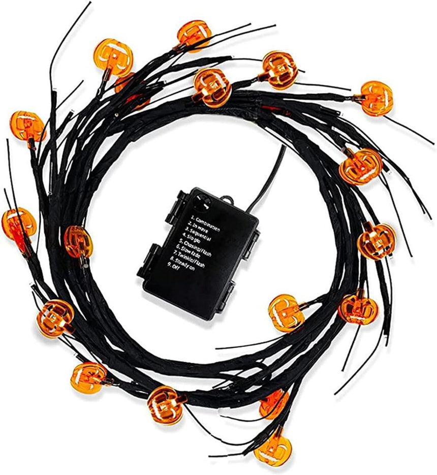 Willow branch light string with orange pumpkin LEDs and a battery box