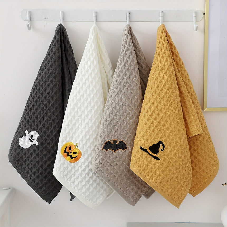 Four waffle towels with embroidered ghost, pumpkin, bat and witch hat