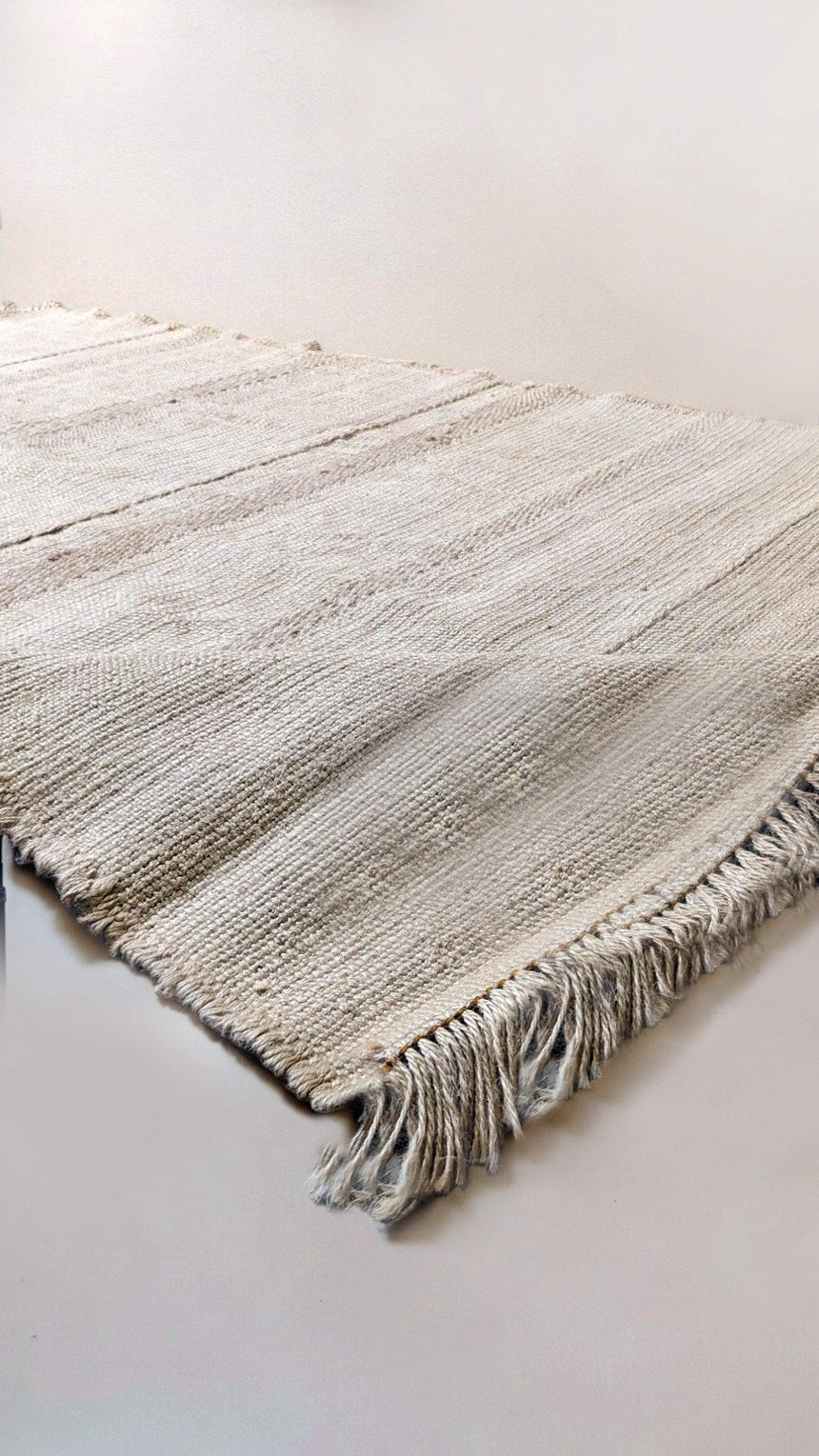 Cream jute rug sample with fringed ends
