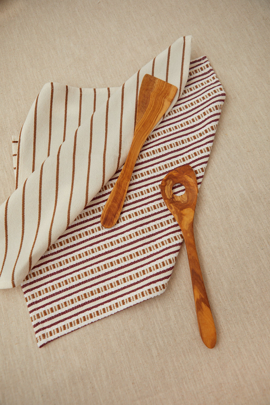 Two tea towels in a burgundy chain-link weave