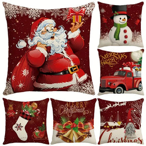 Six red Christmas cushion covers printed with Santa, a snowman and a red truck