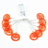 Orange pumpkin LED string lights with a battery box