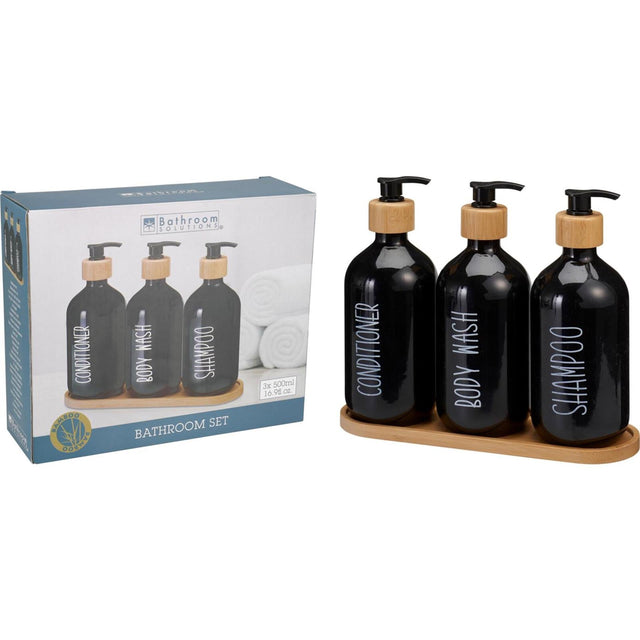 Three matching bathroom dispenser bottles standing together on a tray