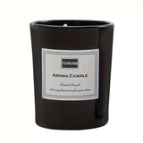Black glass candle jar with a white printed label