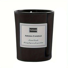 Black glass candle jar with a white printed label