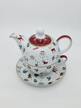 White porcelain teapot stacked on a cup, printed with red and green Christmas motifs