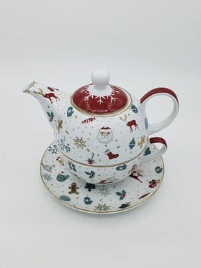 White porcelain teapot stacked on a cup, printed with red and green Christmas motifs