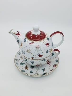 White porcelain teapot stacked on a cup, printed with red and green Christmas motifs