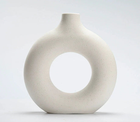 Ceramic vase in matte white with a hollow circular silhouette
