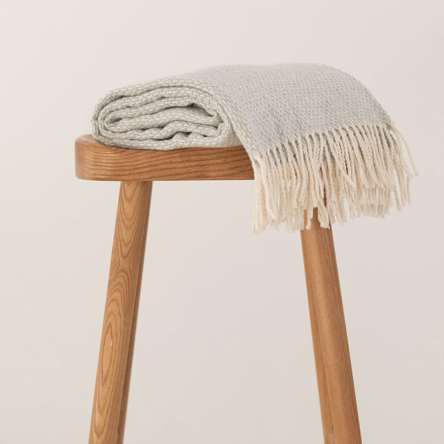 Grey Haze throw with a fringed edge