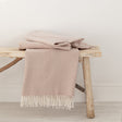 Pink Coast throw with a fringed edge