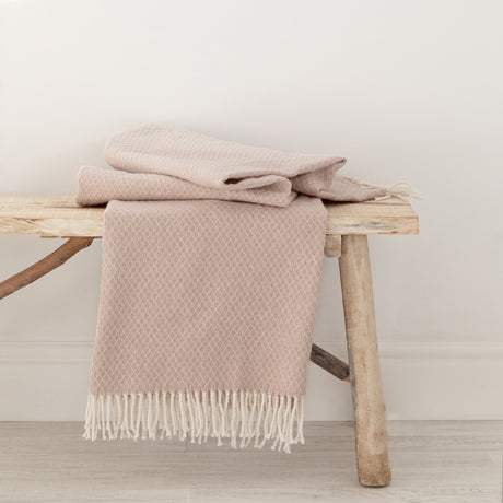 Pink Coast throw with a fringed edge