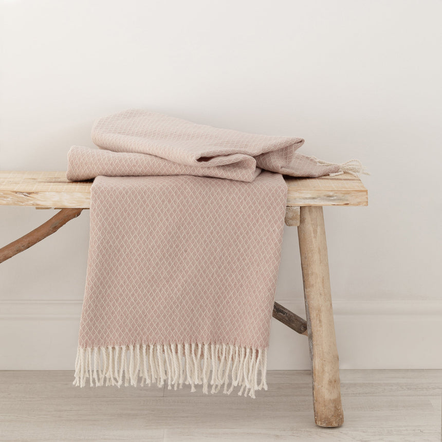 Pink Coast throw with a fringed edge