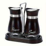 Black salt and pepper shakers on a black stand with a chrome handle