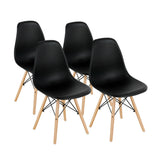Black molded shell dining chair on natural wood legs