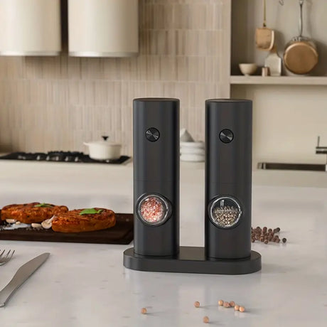 Two electric salt and pepper grinders