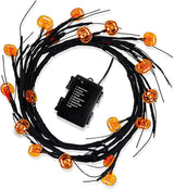 Willow branch light string with orange pumpkin LEDs and a battery box