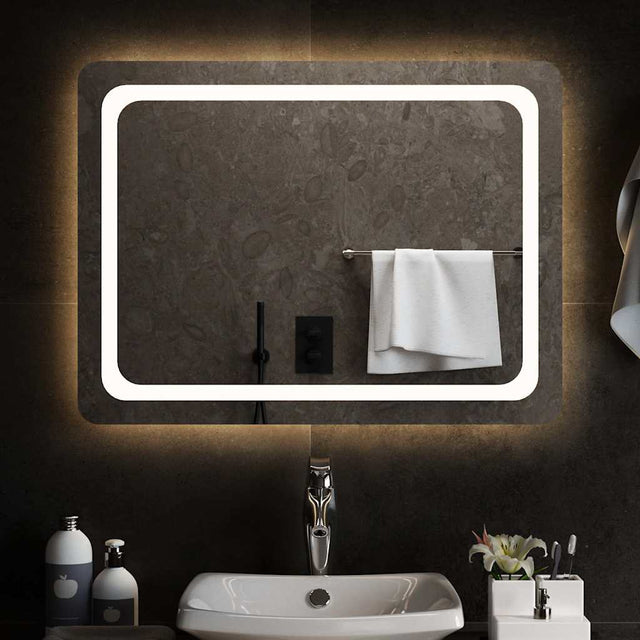 A rectangular bathroom mirror, wider than it is tall, lit around the edge by an integrated LED strip