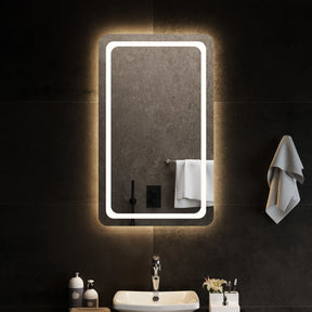 A tall rectangular bathroom mirror, a metre high, lit by an integrated LED strip