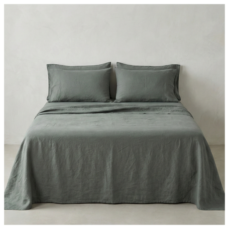 A grey-green linen-cotton sheet set made up on a bed, shown from the front
