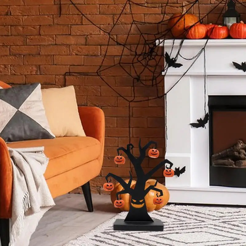 Black iron Halloween tree with hanging pumpkins beside a fireplace