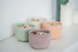 Hand-poured candle in a cement vessel