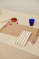 Two placemats in a caramel birdseye weave