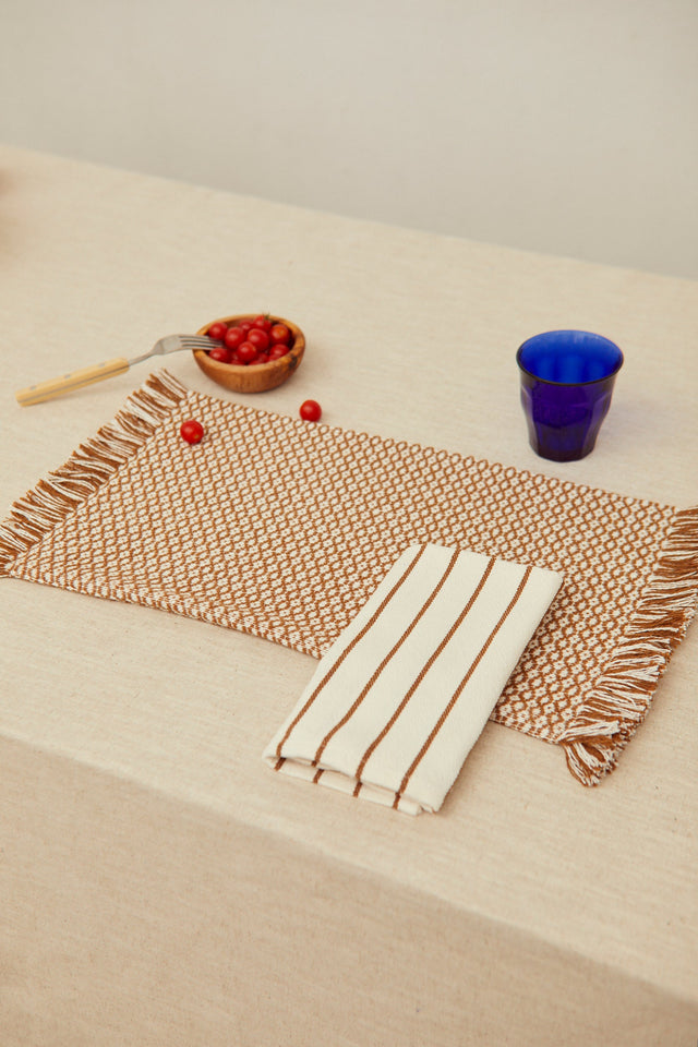 Two placemats in a caramel birdseye weave