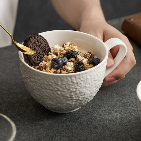 Ceramic coffee cup and saucer with a rough stone-like texture