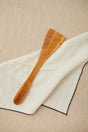 Curved kitchen spatula cut from a single piece of olive wood