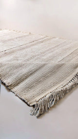 Cream jute rug sample with fringed ends