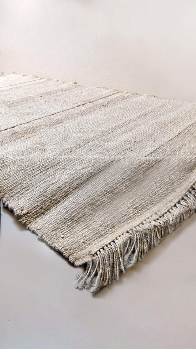Cream jute rug sample with fringed ends