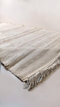 Cream jute rug sample with fringed ends