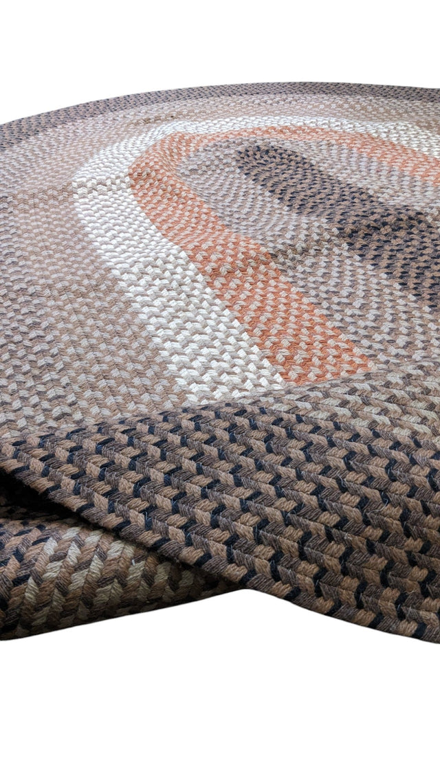 Oval braided jute rug in grey, brown, terracotta and cream bands