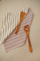 Two tea towels in a burgundy chain-link weave