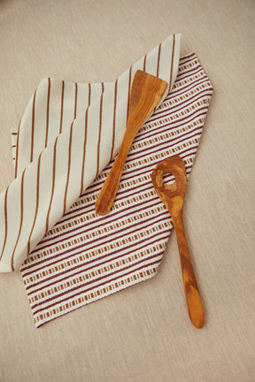 Two tea towels in a burgundy chain-link weave