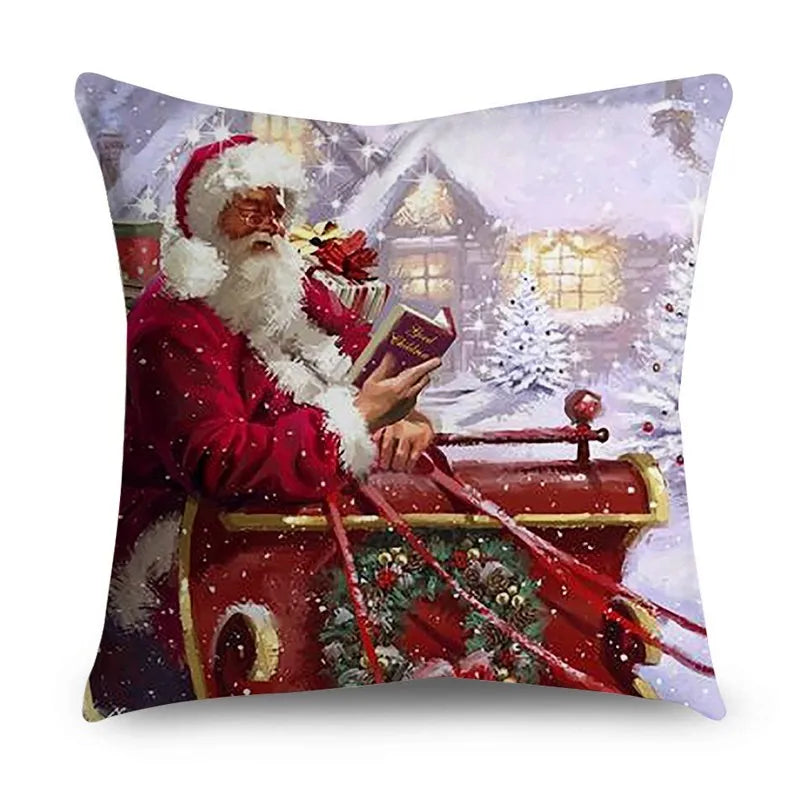 Cushion cover printed with Santa in a red sleigh in front of a snowy house
