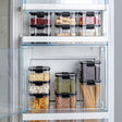 Clear square food storage container with a black locking lid