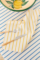 Two cotton napkins in a yellow chain-link weave