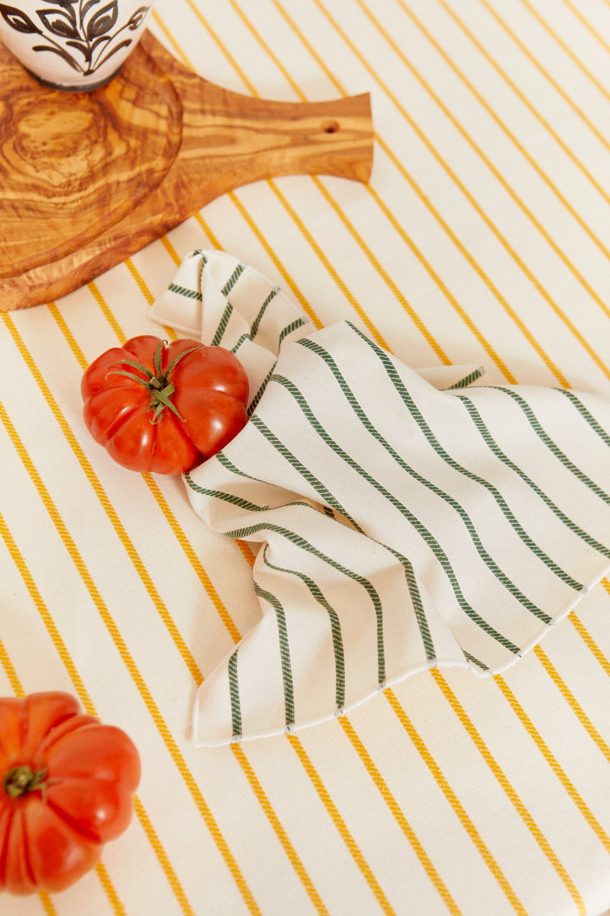 Two cotton napkins in a green chain-link weave