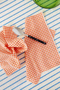 Two cotton napkins in a small orange vichy check