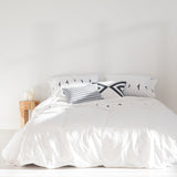 White duvet cover with a line of small black bird silhouettes