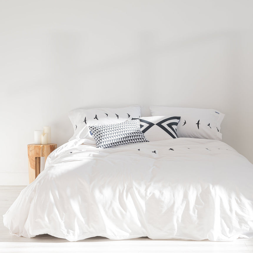 White duvet cover with a line of small black bird silhouettes