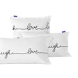 White pillowcases printed with live, love, laugh in black script