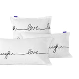 White pillowcases printed with live, love, laugh in black script