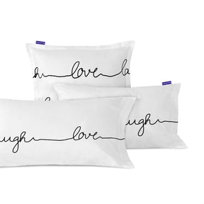 White pillowcases printed with live, love, laugh in black script