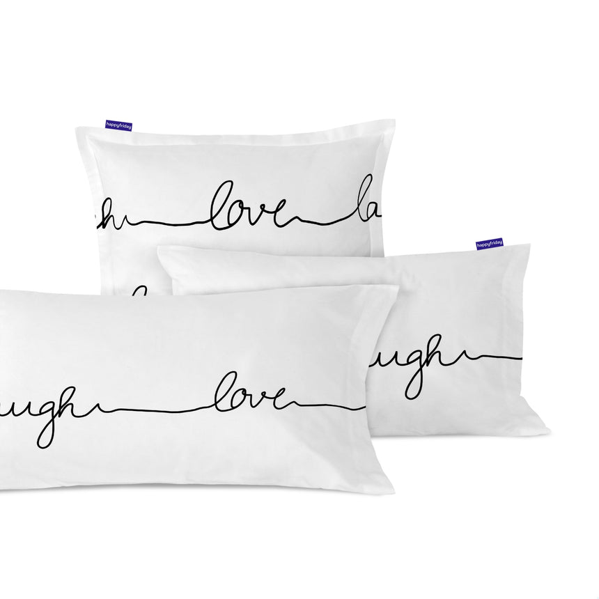 White pillowcases printed with live, love, laugh in black script