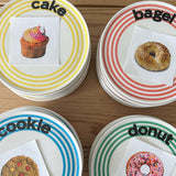 Ceramic dessert plates with yellow, coral, blue and green stripes and printed words