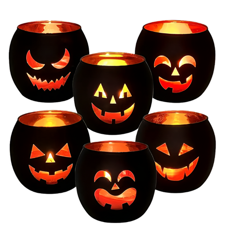 6 black glass candle holders, each with a different pumpkin face, lit from inside