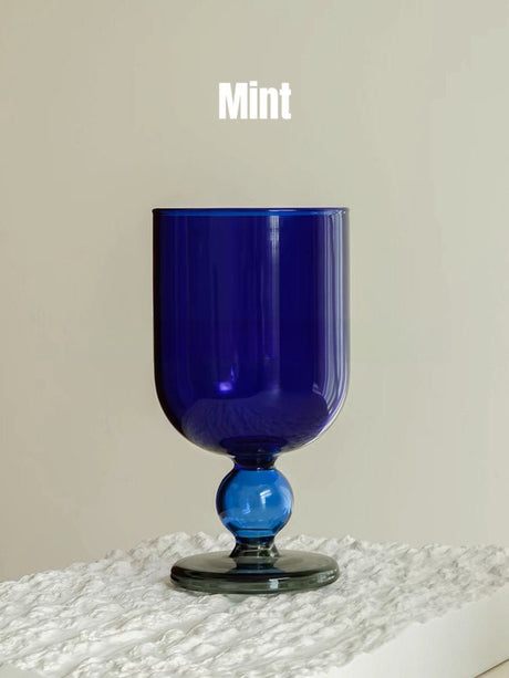 A solid deep blue wine glass with a matching blue gumball stem